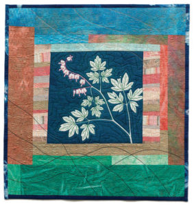 "Bleeding Heart" an art quilt by Sue Reno featuring cyanotype fabrics.