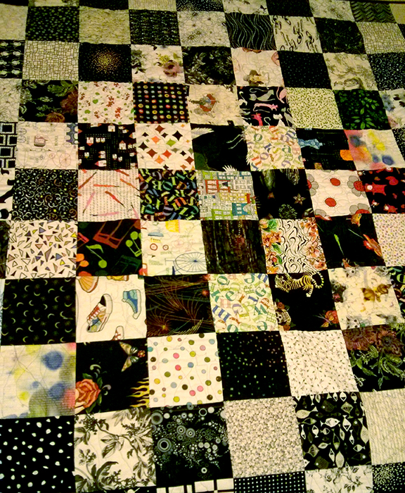 Quilt back with fabric painted squares throughout
